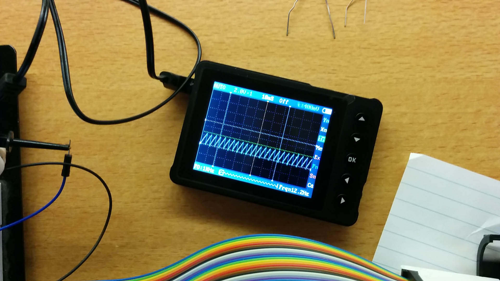 The oscilloscope showing the capacitor charging and discharging as the nozzles are being tested one by one.